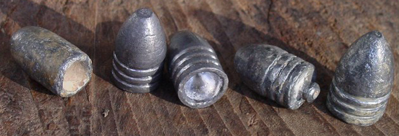 Several Minié style bullets, and a smooth bore round on the left.