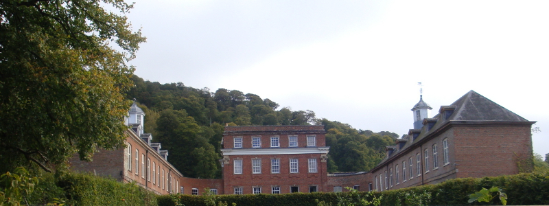 Crowcombe Court stable wings (now apartments) to the left and right, the main house at centre.